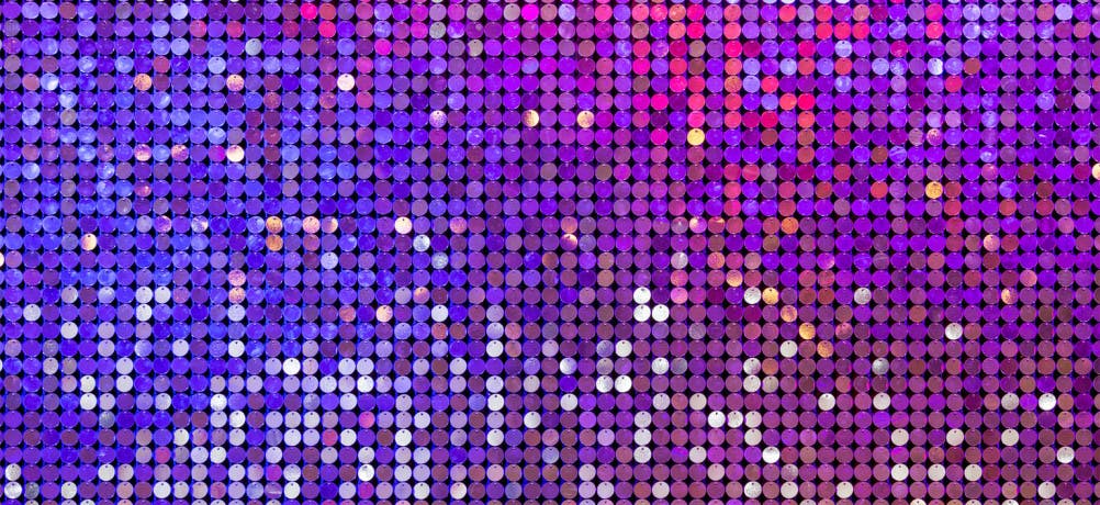 Glittering sequins in purple and pink on the wall