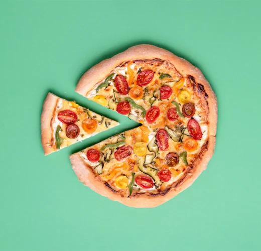 slice taken out of primavera pizza