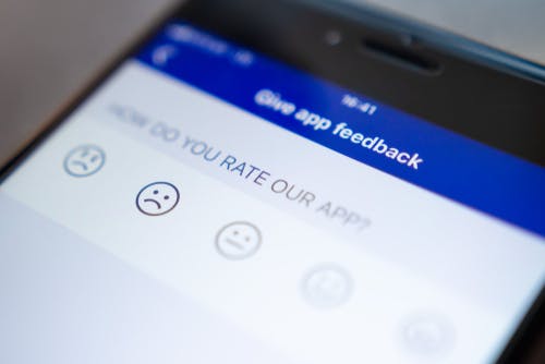 Mobile screen on 'give app feedback' page. Editorial credit: Dzmitrock / Shutterstock.com