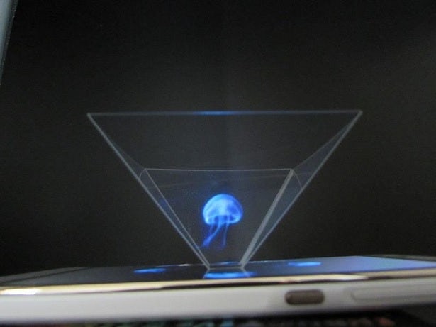 A smartphone on its side, projecting a holographic image of a jellyfish