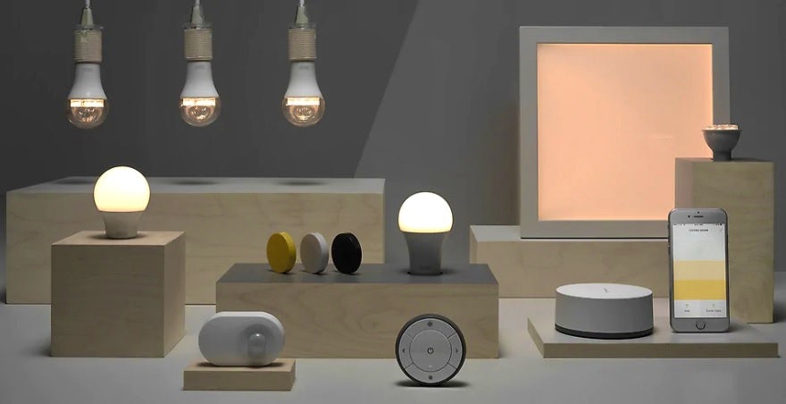 An array of smart lighting products by IKEA, together with a smartphone and devices to control them.