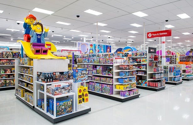 A photograph of Target's reimagined toy store, with two large Lego figures on top of one of the displays.