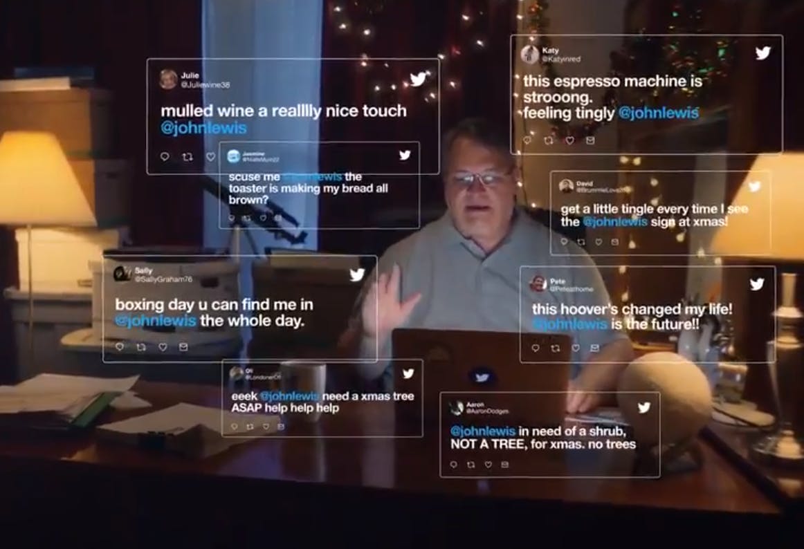 A still from the Twitter John Lewis Christmas ad, showing Mr. Lewis at his desk, with tweets in the air around him.