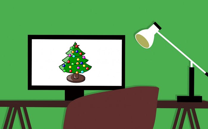 Vector graphic of a desk with an anglepoise lamp and a PC monitor on top. The PC monitor has a Christmas tree displayed on it.