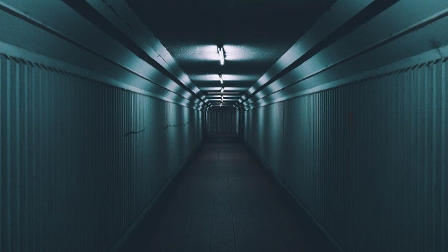 A dark, dimly-lit tunnel