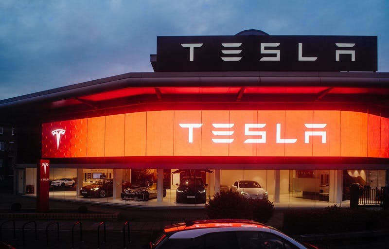 View from the street of Tesla Motors showroom with multiple luxury Tesla cars inside. Tesla is an American company that designs, manufactures, and sells electric cars