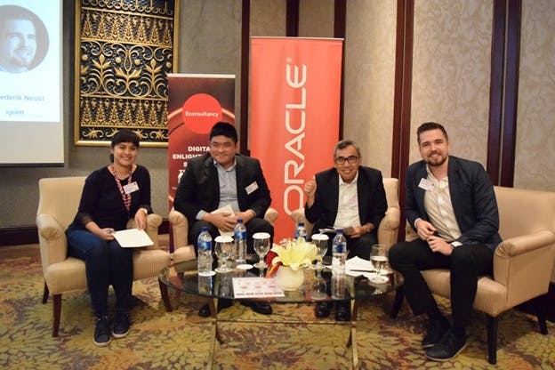 Organisers of the content marketing roundtable gather in front of an Oracle banner