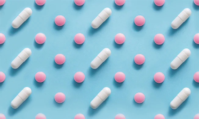 Scattered,Pills,On,A,Blue,Background,,,Medicine,Concept.,Multiple