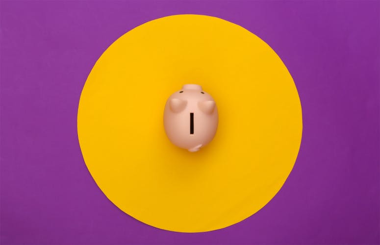 紫色背景上有黄色圆圈的储蓄罐。