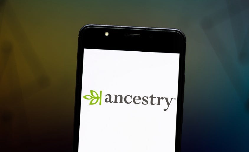 A smartphone screen with the Ancestry logo on it