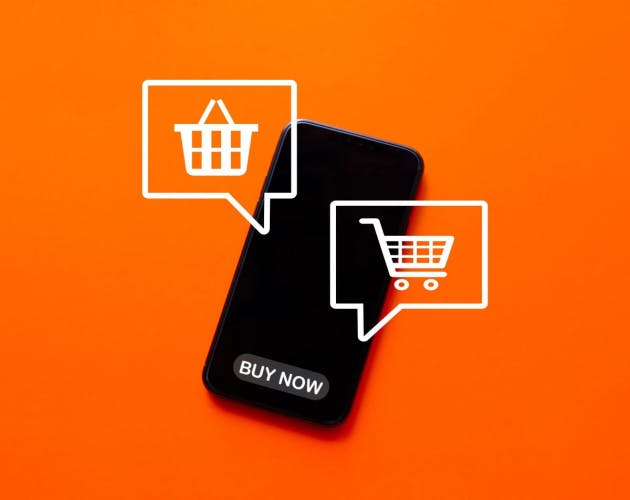 a smartphone with a black screen and the message 'buy now' on an orange background. There are two white speech bubbles superimposed on the phone, one with the icon of a shopping basket, the other with the icon of a shopping trolley