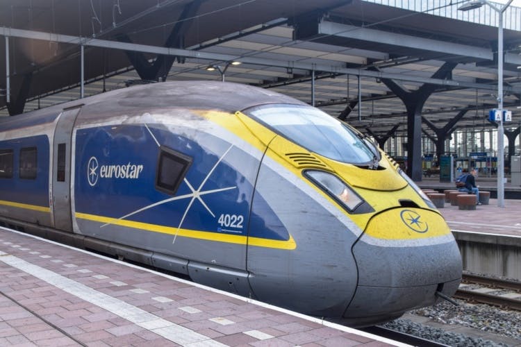 A Eurostar International High Speed passenger train in blue and yellow colours with the logo visible.